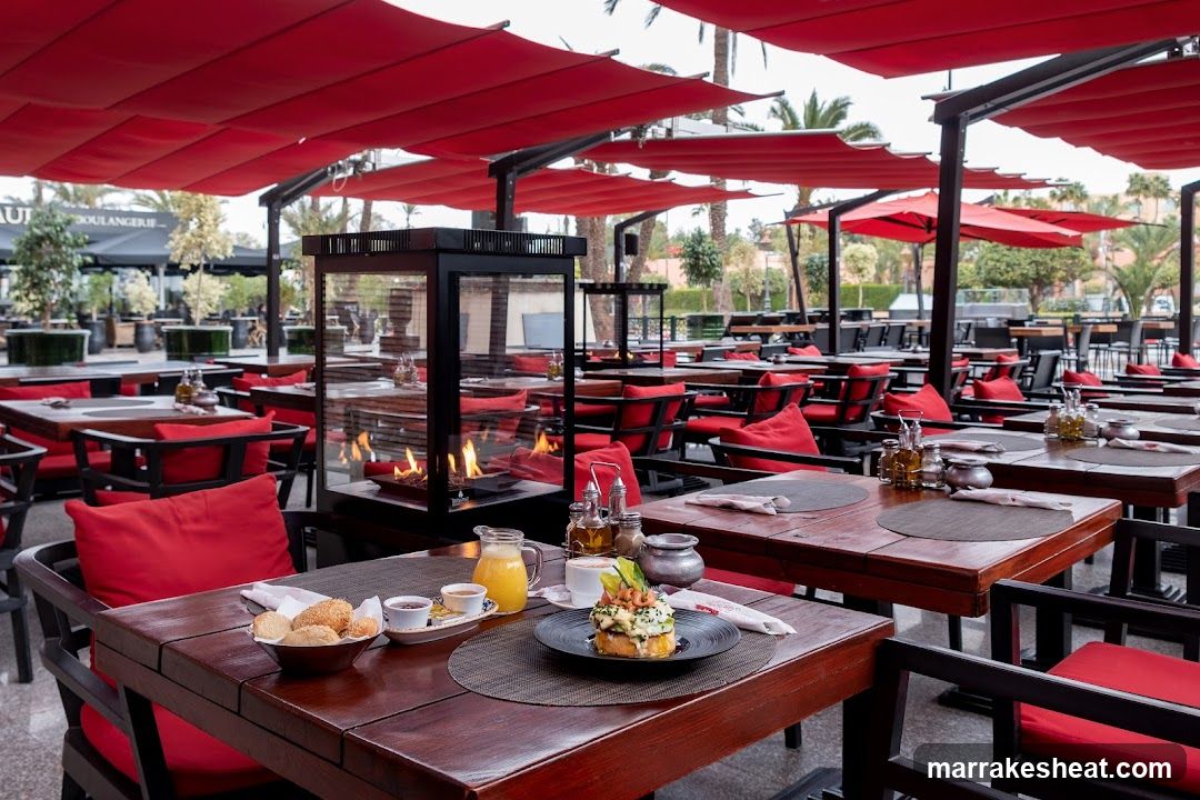 Outdoor Dining Area with Red Umbrellas and Fire Pit