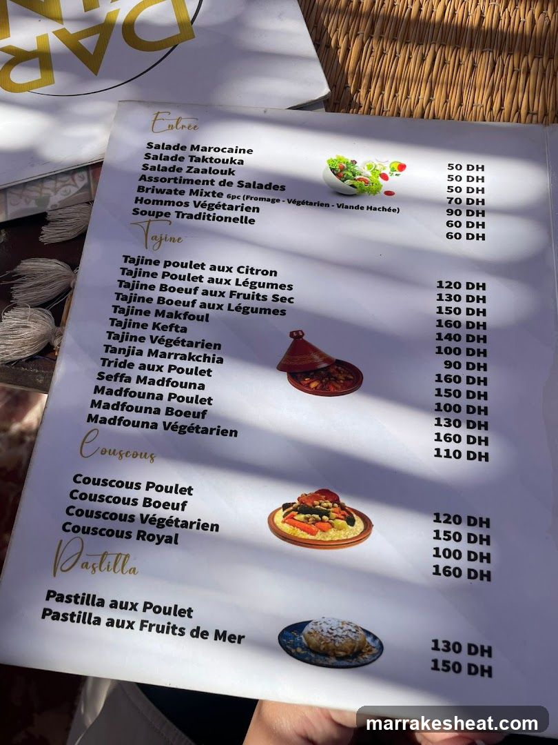 A printed menu featuring Moroccan dishes with prices in DH, including salads, tajines, couscous, and pastilla.