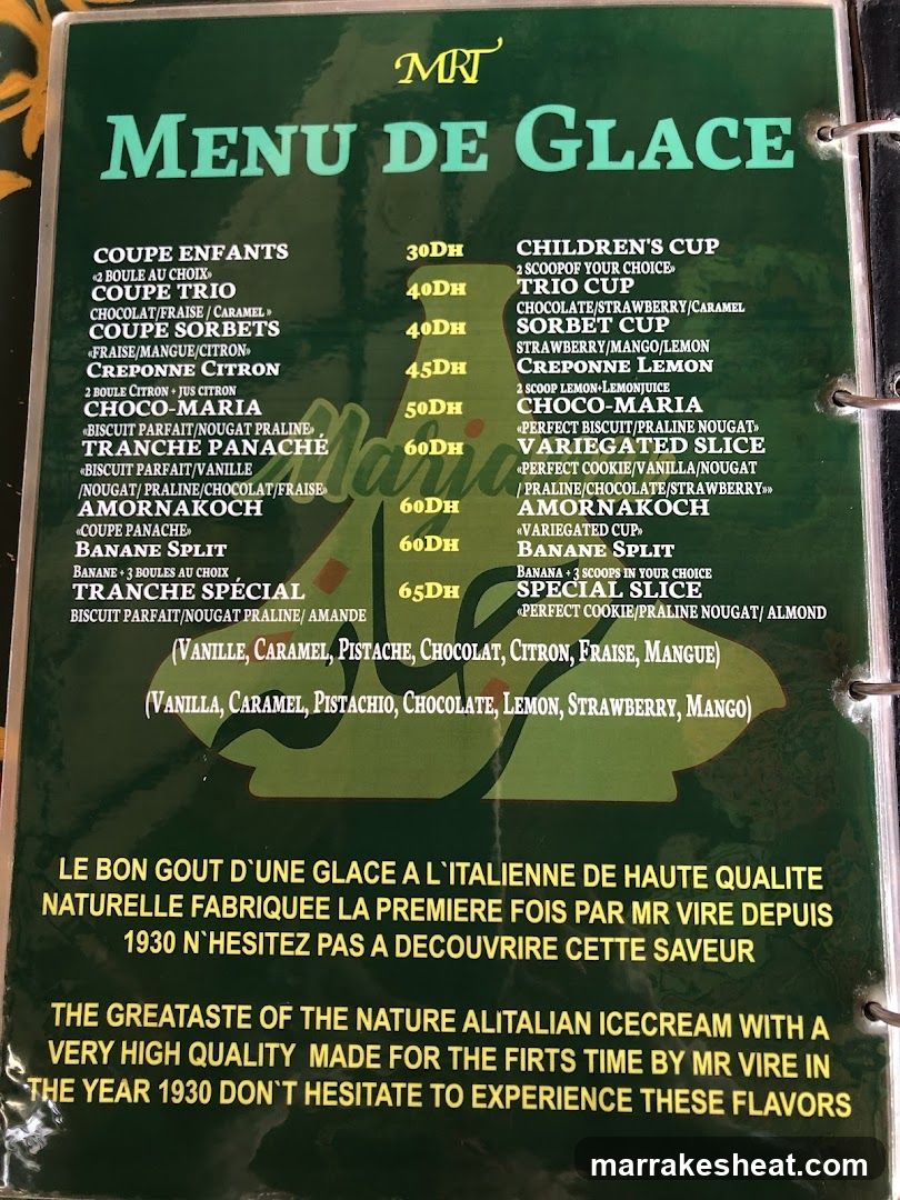 A green menu board listing ice cream flavors and prices in French and English, featuring items like Coupe Enfants, Trio Cup, Sorbet Cups, and Banane Split.