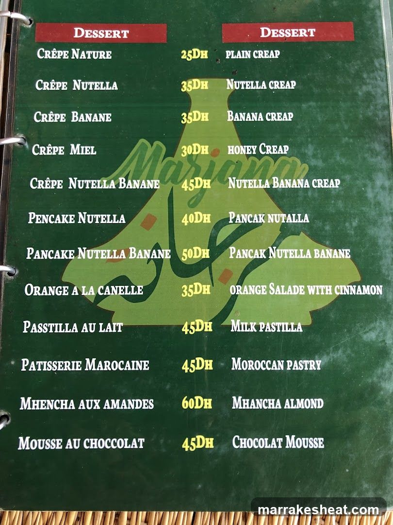 A green menu board listing dessert items with prices in DH, featuring crepes and pancakes.