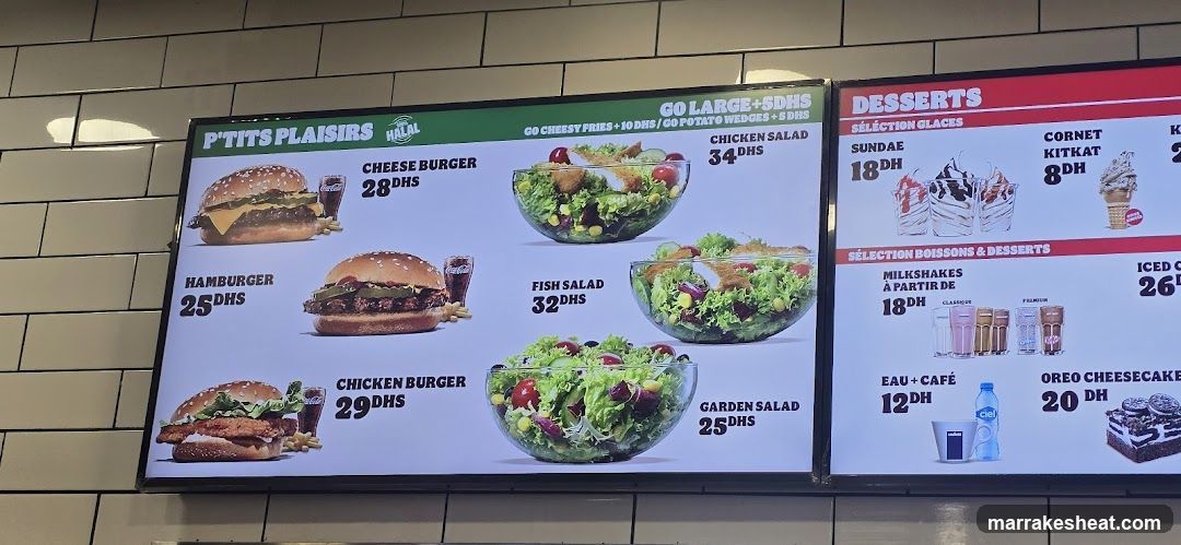 Digital menu board displaying burgers, salads, and desserts with prices in DH.