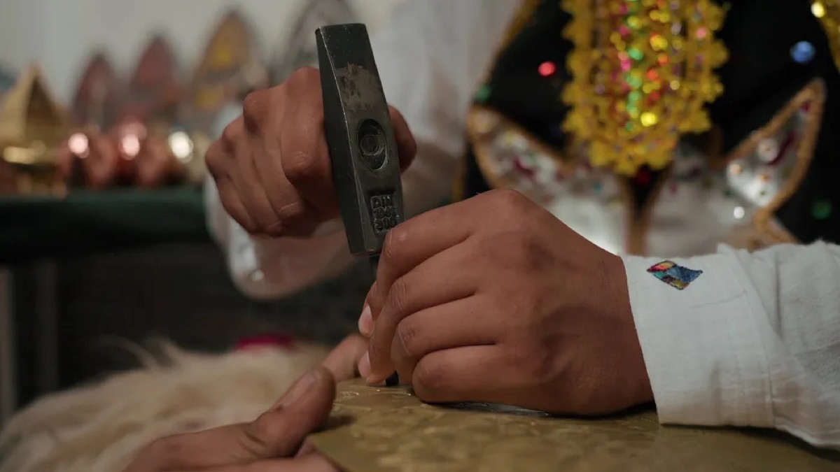 Artisan working metal during Marrakech Folklore Days